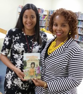Presenting Kindergarten Teacher Lena Leon with a copy of Junebug for the Collins Elementary School Library.